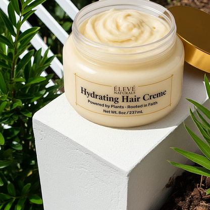 Jar of Elevé Naturals Hydrating Hair Creme on a white block with greenery in the background